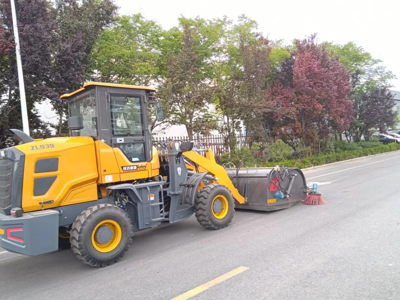 Loader sweeper clearing road