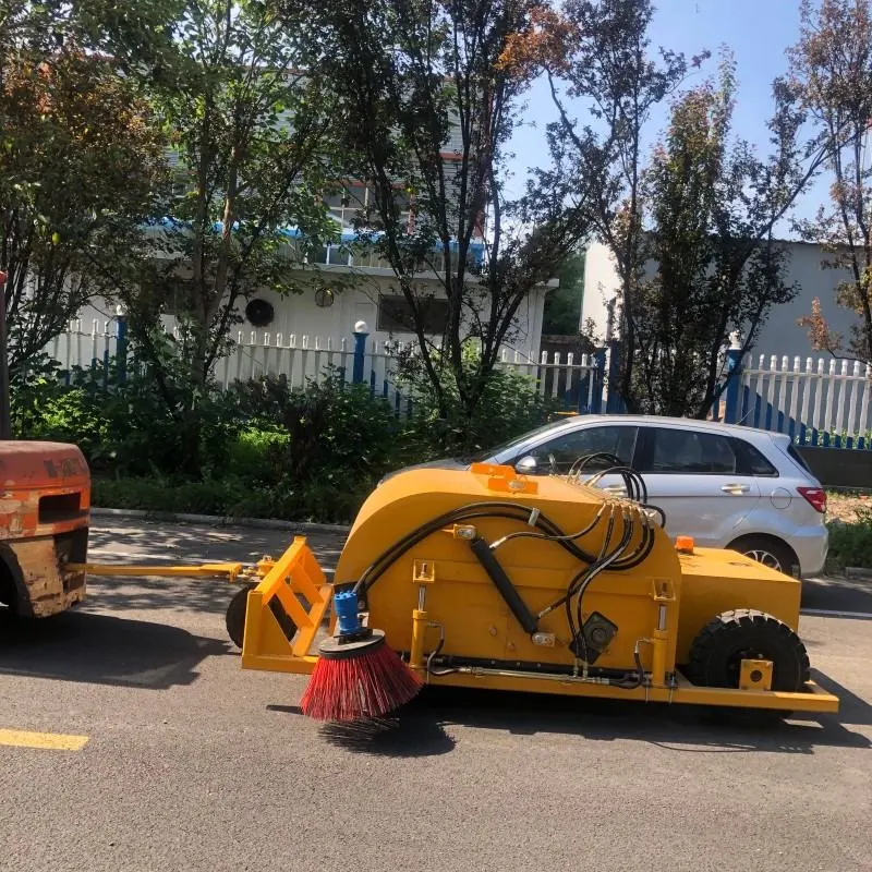 Towed trailer sweeper in operation